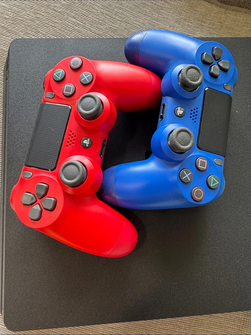 Sony PS4 Slim Console with Red and Blue DualShock Controllers